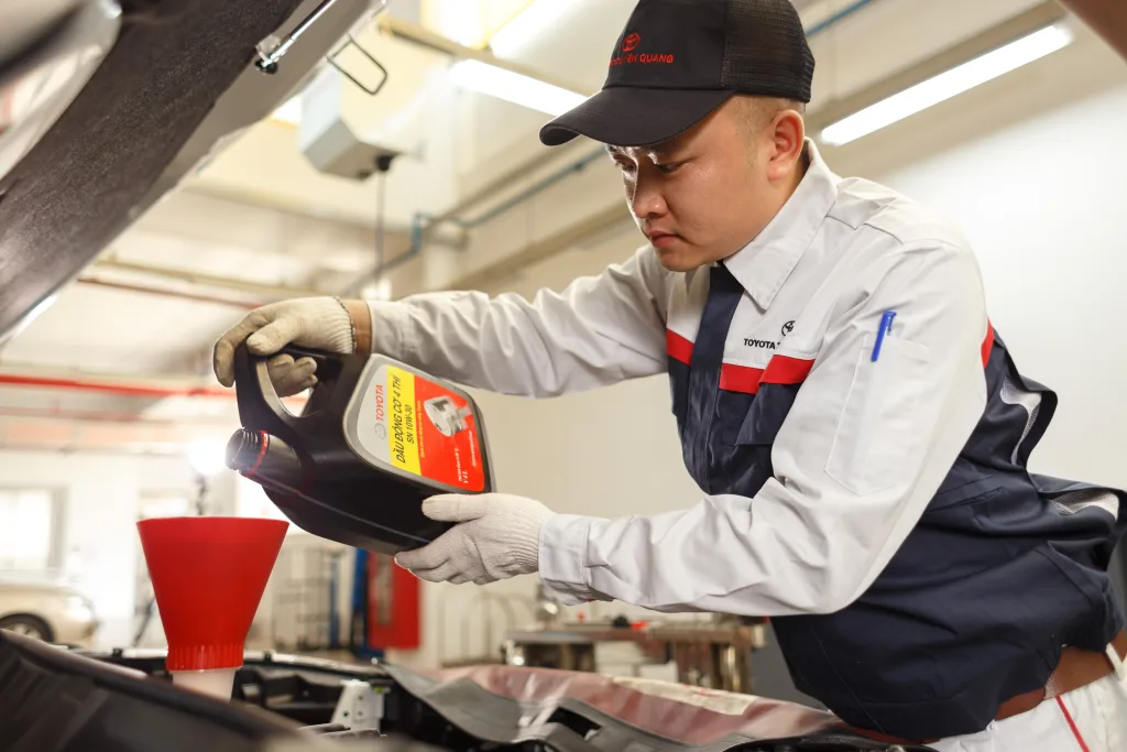 worker doing oil change in Toyota workshop