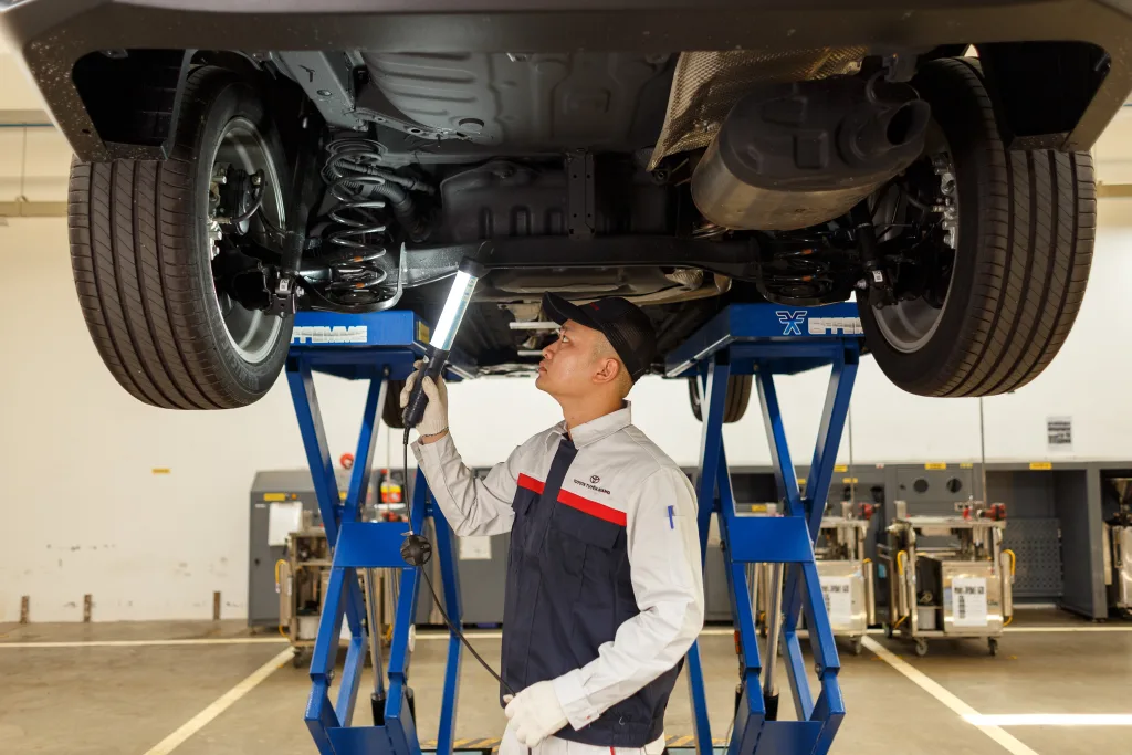 technician checking car underground