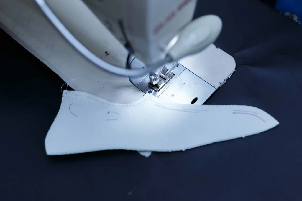 Artistic photography of a shoe being sewed