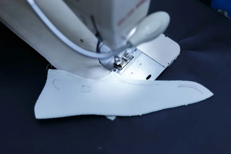 Artistic photography of a shoe being sewed