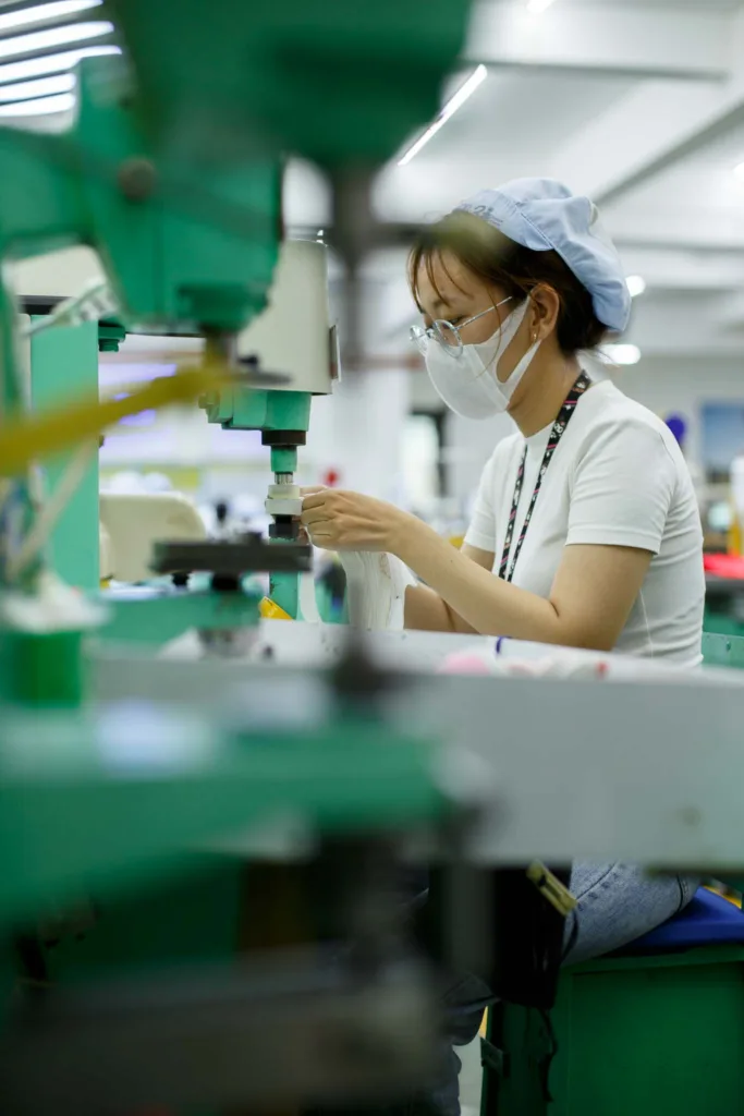 a woman worker working with stamping machine in a textile and garment factory